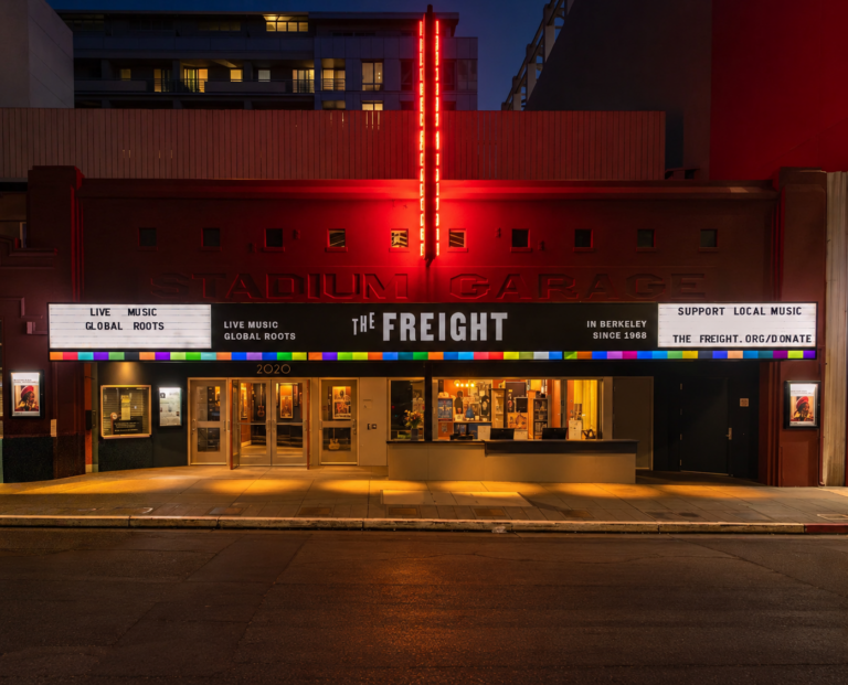 Außenansicht des Musikclubs The Freight in Berkeley, Kalifornien, nachts beleuchtet mit roter Neonreklame und einem hell erleuchteten Vordach.